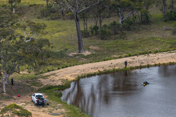 Police Divers search a dam in the Southern Highlands on Monday. 