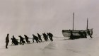 The James Caird being towed across ice in Antarctica by Ernest Shackleton and the crew of the Endurance.