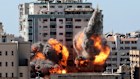 A ball of fire erupts from the media building in Gaza City after an Israeli airstrike.