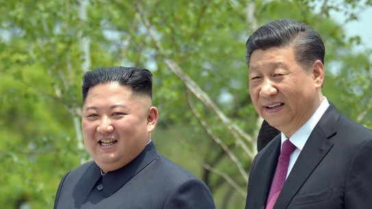 North Korean leader Kim Jong Un, left, and Chinese President Xi Jinping stroll in the premises of Kumsusan guest house in Pyongyang, North Korea in June of last year.