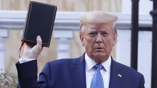 "You have to dominate": US President Donald Trump poses with a Bible outside St John's Episcopal Church.

