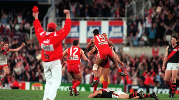 Sydney Swans players congratulate Tony Lockett after he kicked a behind to put them through to the grand final.