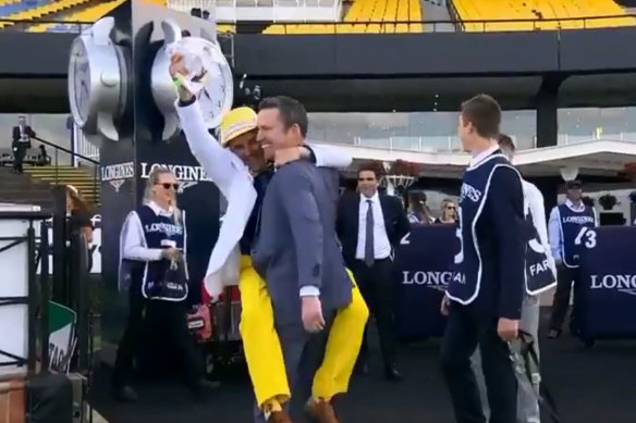 Neil Paine (yellow trousers) celebrates with Adrian Bott after winning Golden Slipper with Farnan.