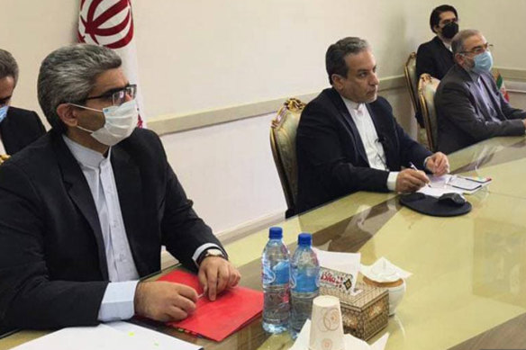 Iranian diplomats attend a virtual talk on the nuclear deal with representatives of world powers in Tehran on Friday.