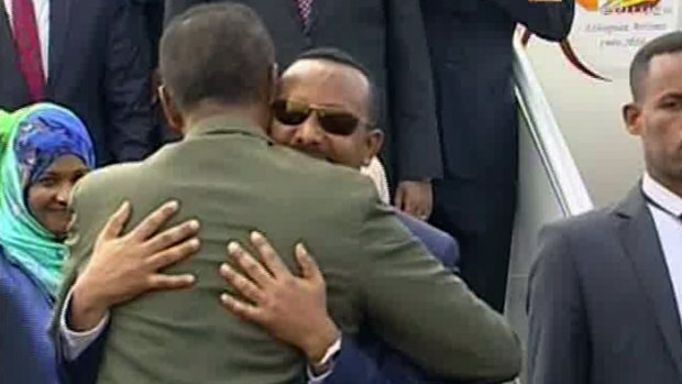 Ethiopian Prime Minister Abiy Ahmed is welcomed by Eritrean President Isaias Afwerki as he arrives in Eritrea on Saturday.