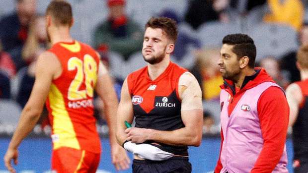 Cruel blow: Demon Joel Smith leaves the ground after being injured in a tackle against the Suns.