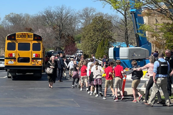 Children from The Covenant School in Nashville, Tennessee, hold hands as they are taken to a church after the shooting.