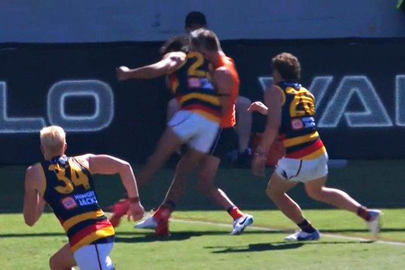 Adelaide’s Shane McAdam makes contact with GWS wingman Jacob Wehr.