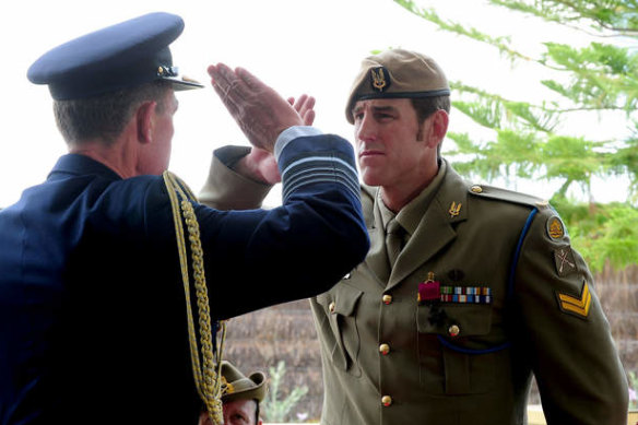 Then Defence Force chief Angus Houston salutes Victoria Cross recipient Ben Roberts-Smith in 2011.