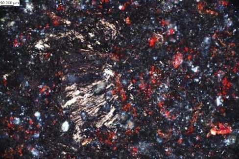 Sarytogan Graphite’s micro-photograph of haematite alteration (red) in graphitic ore material from its Central Graphite Zone in Kazakhstan.