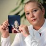 Virginia Giuffre in 2022, with a photo of herself as a teenager.