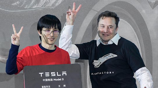 Tesla CEO Elon Musk with car owners at the company’s Shanghai factory. 