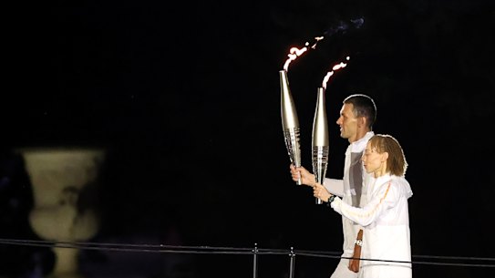 Torchbearers Alexis Hanquinquant and Nantenin Keita of Team France carry the Paralympic Flames.