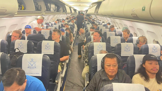 Australian and international cricketers on board a charter flight from Pakistan to Dubai following the postponement of the Pakistan Super League.