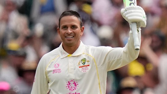 Usman Khawaja raises his bat after reaching 100 against England on Thursday.