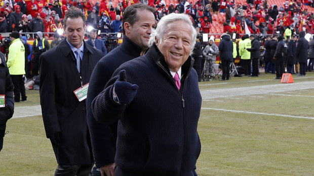 Charges laid: Robert Kraft (right) arrives on the field on the day of the AFC Championship game against Kansas City.