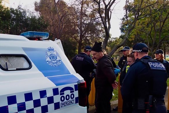Hank Ferguson being arrested on August 4 after locking his foot to a drilling rig at the Flemington estate for four hours. 