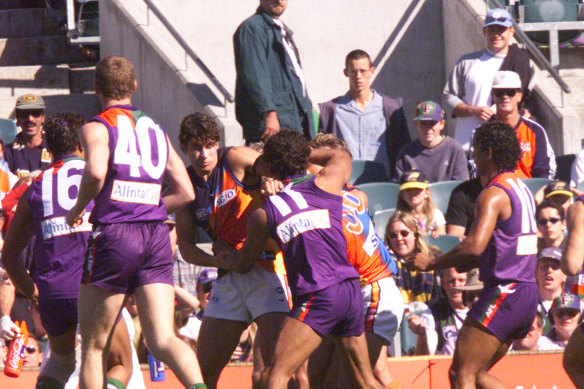 Players wrestle during the “demolition derby”.