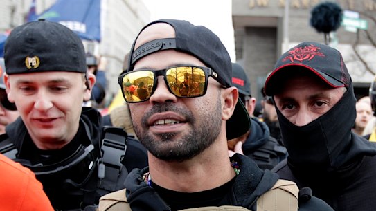 Supporters of President Donald Trump who are wearing attire associated with the Proud Boys watch during a rally at Freedom Plaza in Washington, DC.