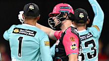 BRISBANE, AUSTRALIA - JANUARY 18: Steve Smith of the Sixers talks with Usman Khawaja of the Heat after being distracted by a spectator in the crowd during the BBL match between Brisbane Heat and Sydney Sixers at the The Gabba, on January 18, 2026, in Brisbane, Australia. (Photo by Bradley Kanaris/Getty Images)