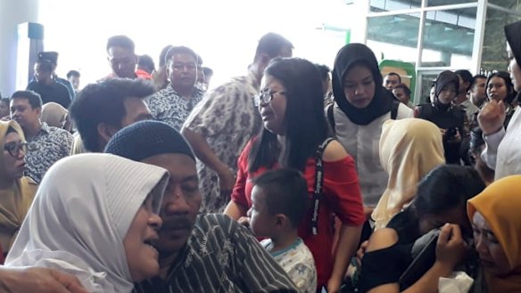 Relatives of passengers comfort each other at Depati Amir Airport in Pangkal Pinang as they wait for news on a Lion Air plane that crashed off Java Island.