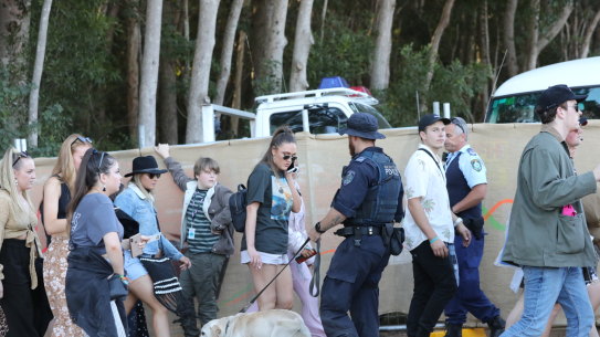 A police sniffer dog checks revellers at a music festival.