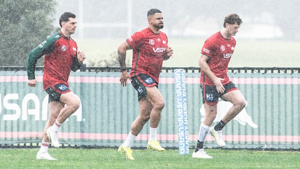 Latrell Mitchell stretches out at a wet Heffron Park on Monday morning.