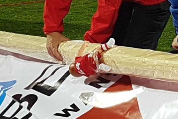 Look closely: A Dane Rampe doll clings to the side of the Sydney banner post