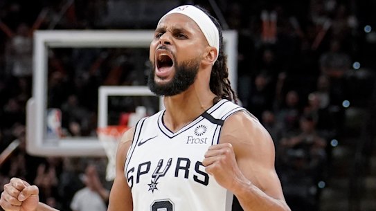 Patty Mills celebrates a basket against the Heat.