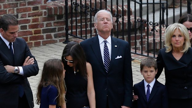 Joe Biden, centre, pauses alongside his family as they to enter a visitation for his son, former Delaware attorney-general Beau Biden, after he died of brain cancer aged 46 in 2015.