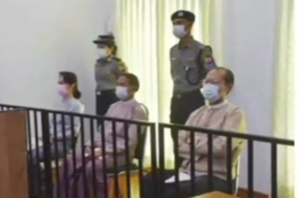 Deposed Myanmar leader Aung San Suu Kyi, left, was shown on TV sitting in court.