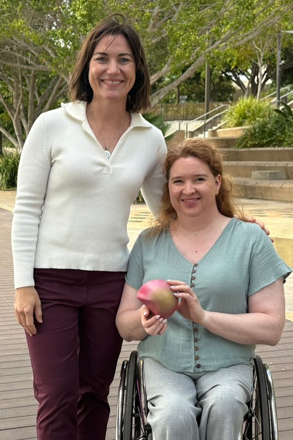 Athletes Anna Meares and Angie Ballard holding the third piece of the Brisbane 2032 emblems as part of a multiday rollout.