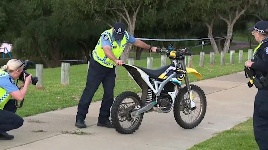 Police examine an electric off-road motorbike involved in a fatal crash in Edgewater on Saturday.