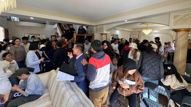 People turn out for the auction of a six-bedroom, five-bathroom home at 116 Belvedere Crescent, Sunnybank Hills.