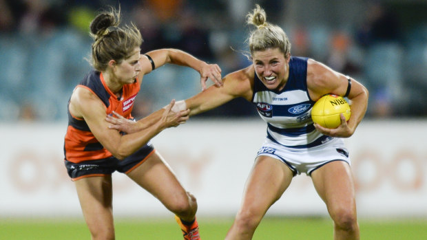 Brush off: Greater Western Sydney's Ellie Brush pressures Melissa Hickey of the Cats during the Giants' round 7 win over Geelong on Friday night.