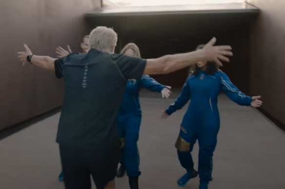 The clip also shows Branson greeting crewmates dressed in their flight suits.