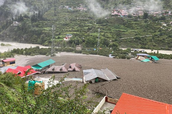 Floodwaters and mud surged down the mountain, crashing into the village, and sweeping away houses.