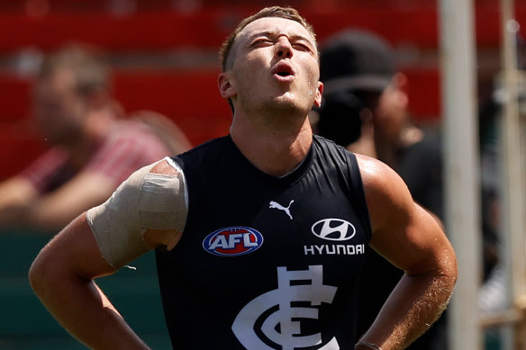 Patrick Cripps leaves the field in pain.