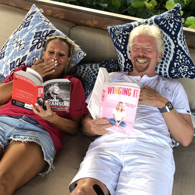 Isaacs and her mentor, British billionaire Richard Branson, enjoy each other’s book while in the Caribbean.