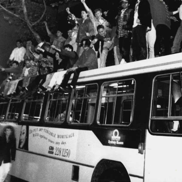 Sydneysiders celebrate on top of a bus in George Street after the announcement in Monte Carlo. September 24, 1993. 