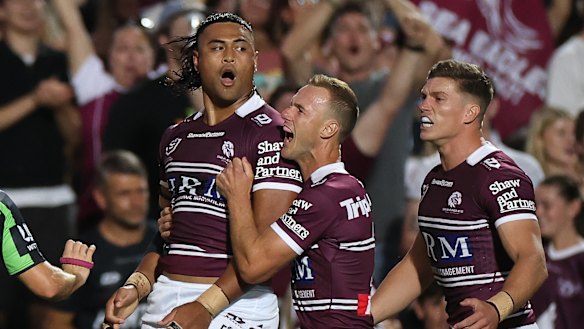 Haumole Olakau’atu celebrates with DCE and teammates after scoring at Brookvale.