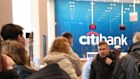 Russian customers queue at a Citibank ATM in Moscow on Monday to withdraw their cash. 