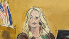 Stormy Daniels testifies as a promotional image for one of her shows is displayed ona  monitor. 