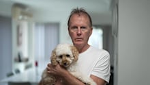 Scott with his two-year-old cavoodle Rosie.