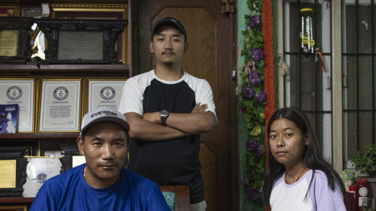 Kami Rita Sherpa with his son, Lakpa Tenzing, and his daughter, Pasang Dolma, at home in Kathmandu.