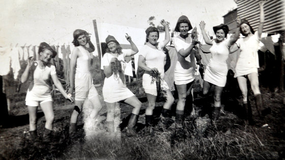 Necia Combe (second from left) with a colander on her head enjoying the company of other Land Army women. 