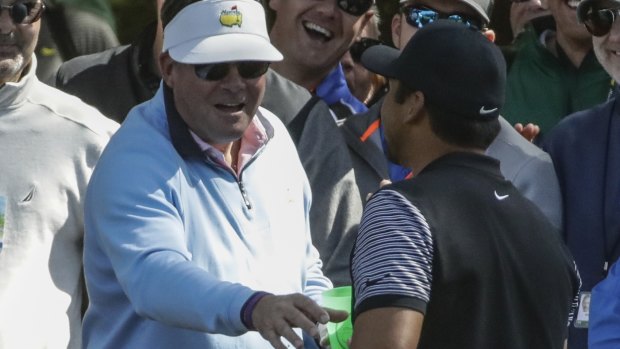 Driven to drink: Jason Day collects his ball out of a fan's beer cup.