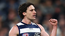 Gryan Miers of the Cats celebrates kicking a goal.