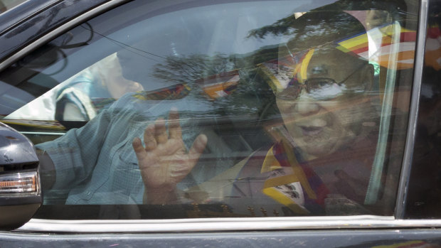 Tibetan spiritual leader the Dalai Lama greets devotees as he arrives in Dharmsala after a hospital stay.