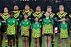 Kangaroos players stand together for the national anthem.